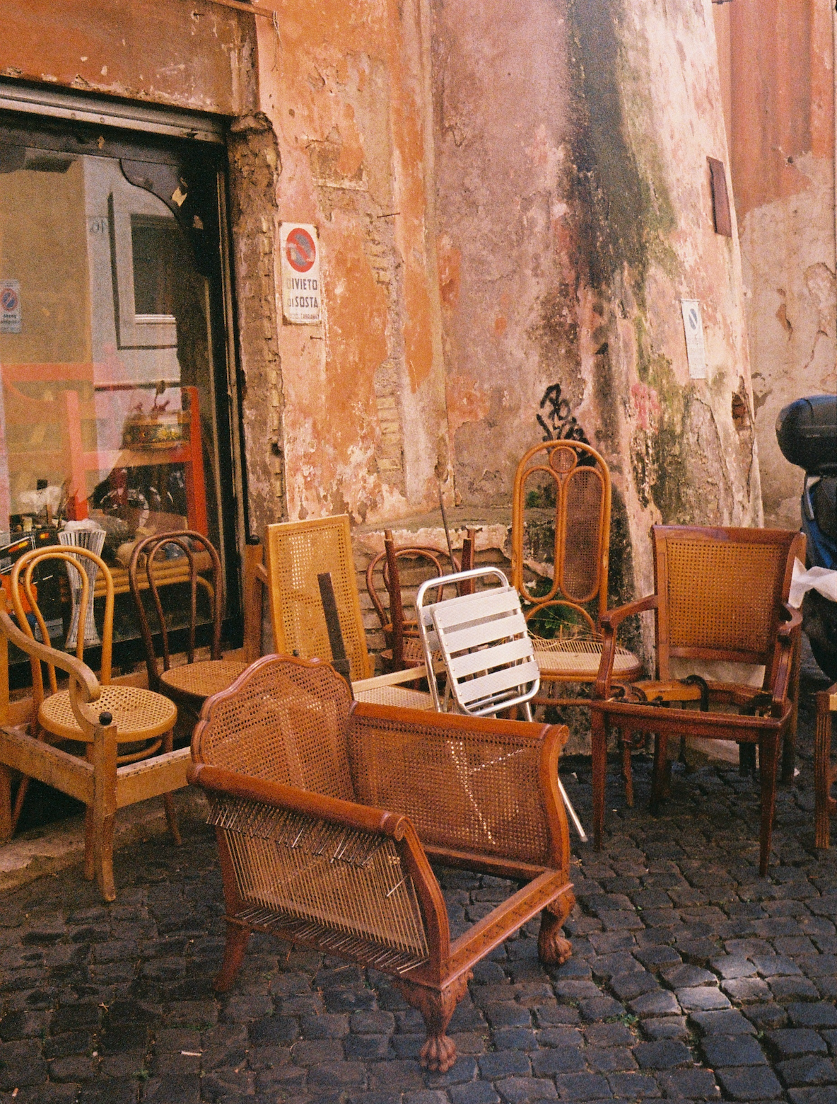Wicker chairs on a cobblestone street
